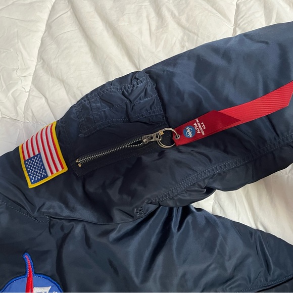 Navy blue bomber jacket With orange inside 
Goes for $300
Flips inside out - Picture 3 of 7